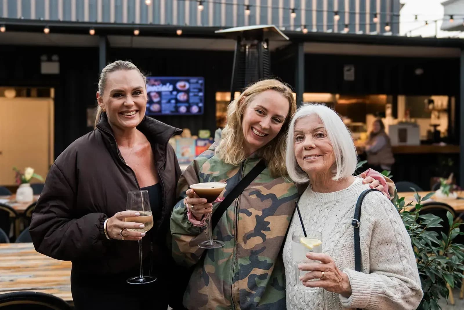 Three guests with drinks at the bar at The 383