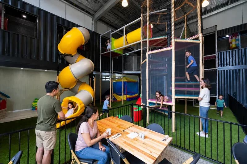 Kids on the double-storey Playpen slide at The 383 Wooli